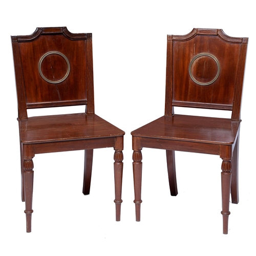 Appraisal: A pair of Regency brass mounted mahogany hall chairs the