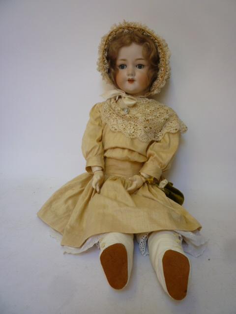 Appraisal: An Armand Marseille bisque head girl doll with blue glass