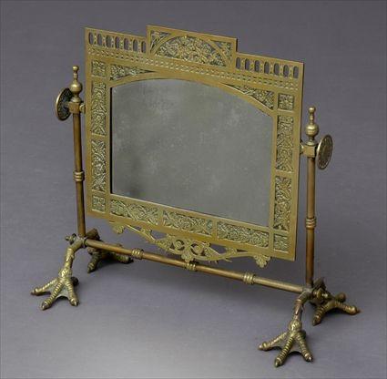 Appraisal: BRASS AESTHETIC MOVEMENT TABLE MIRROR The pivoting mirror frame with