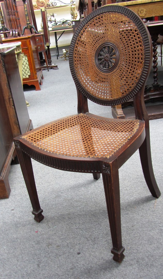 Appraisal: A pair of George II style caned mahogany hall chairs