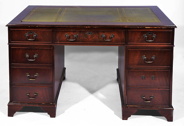 Appraisal: A TH CENTURY MAHOGANY VANEERED PEDESTAL DESK with a leather