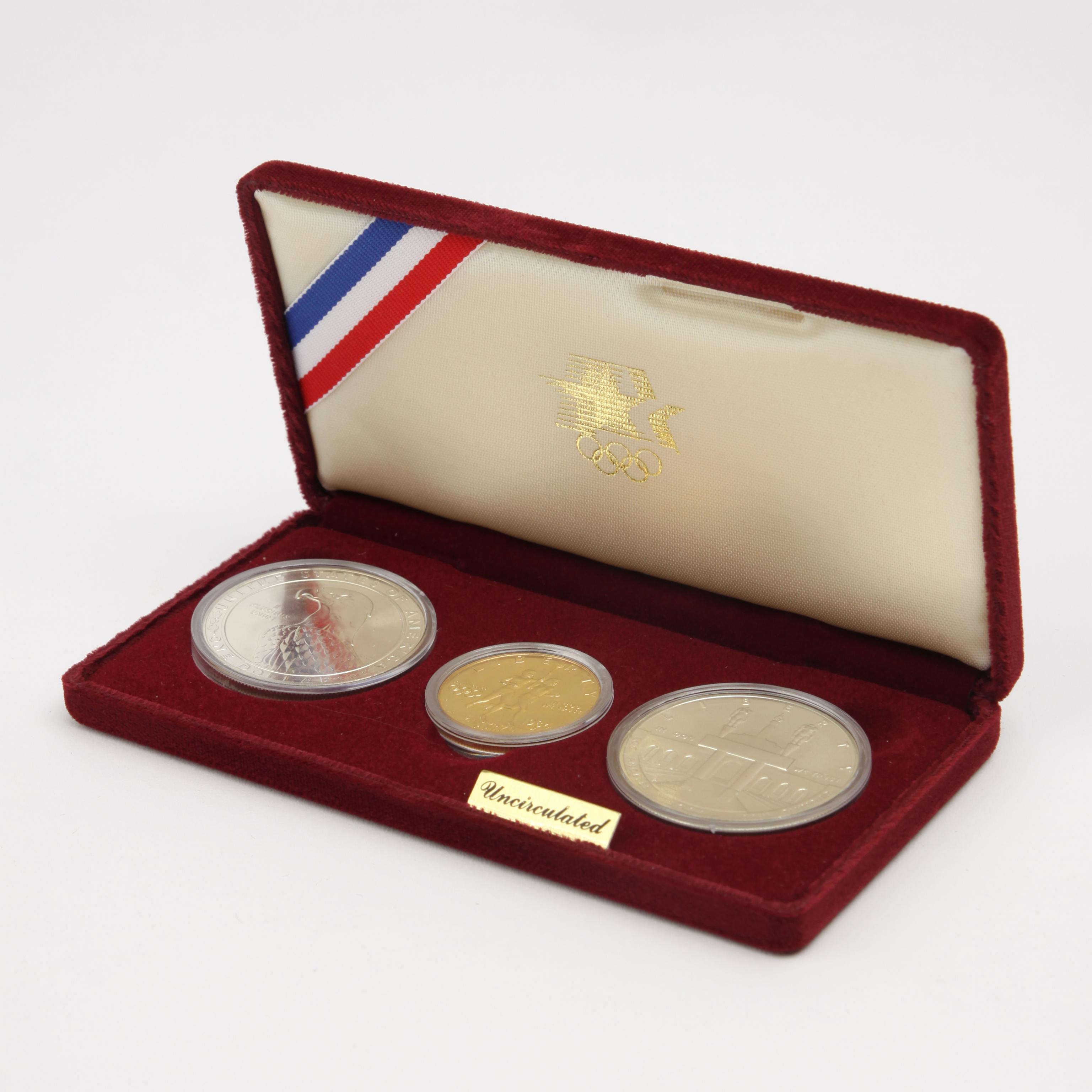 Appraisal: OLYMPIC GOLD AND SILVER COIN SET Set of three uncirculated