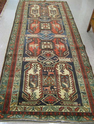 Appraisal: PERSIAN TRIBAL AREA RUG Caucasian influence featuring four large geometric