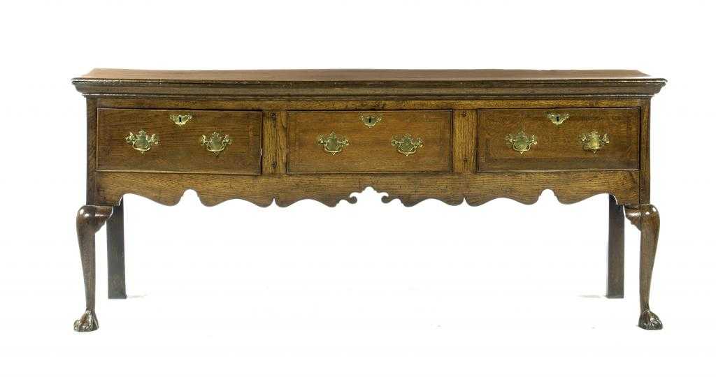 Appraisal: AN OAK DRESSER with moulded top and fitted three crossbanded