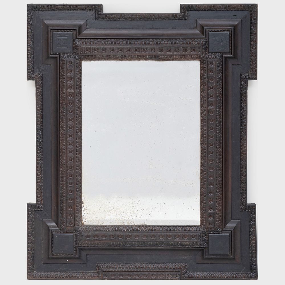 Appraisal: Flemish Carved Ebonized Mirror Fitted with an antiqued beveled mirror