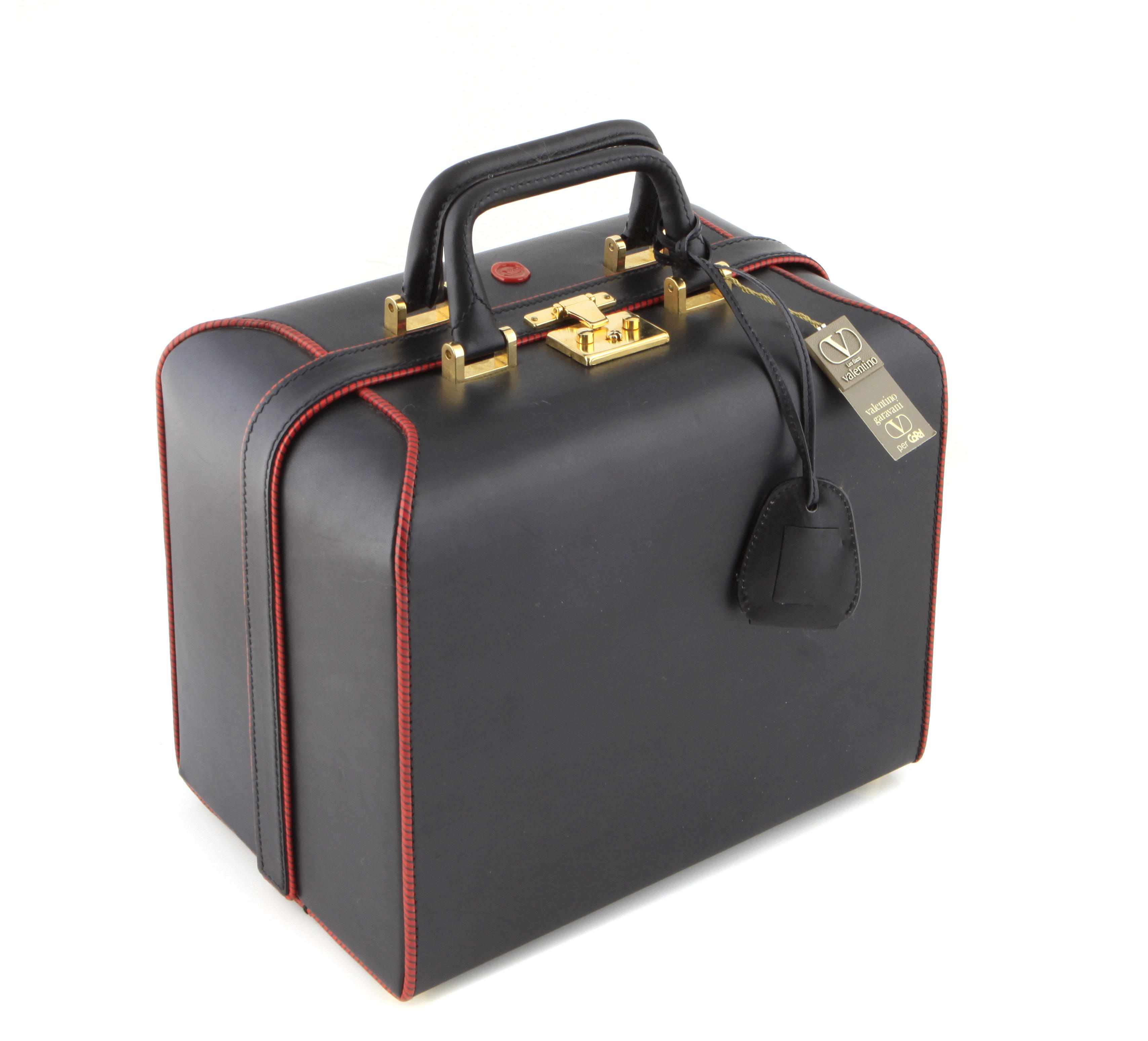 Appraisal: A Valentino leather and red trim travel box size in