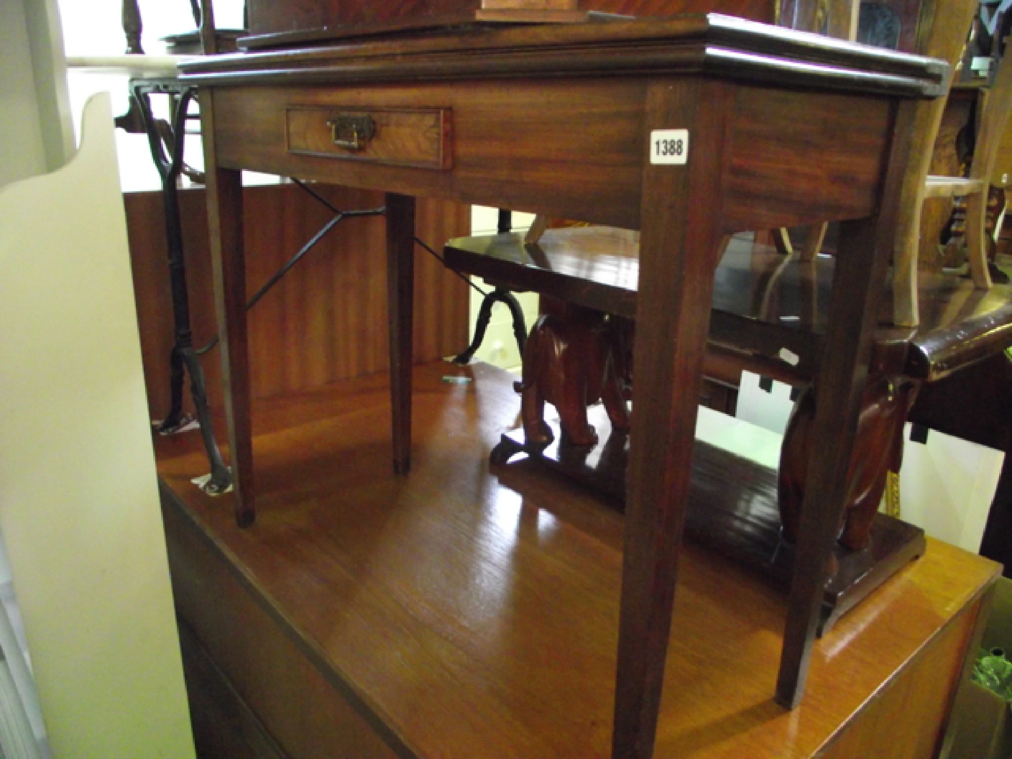 Appraisal: A Georgian mahogany tea table on square tapered legs enclosing