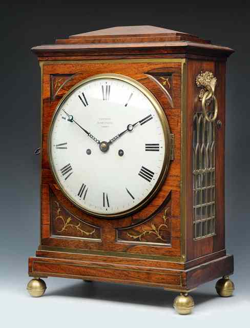 Appraisal: A REGENCY ROSEWOOD TABLE CLOCK the white enamel convex Roman