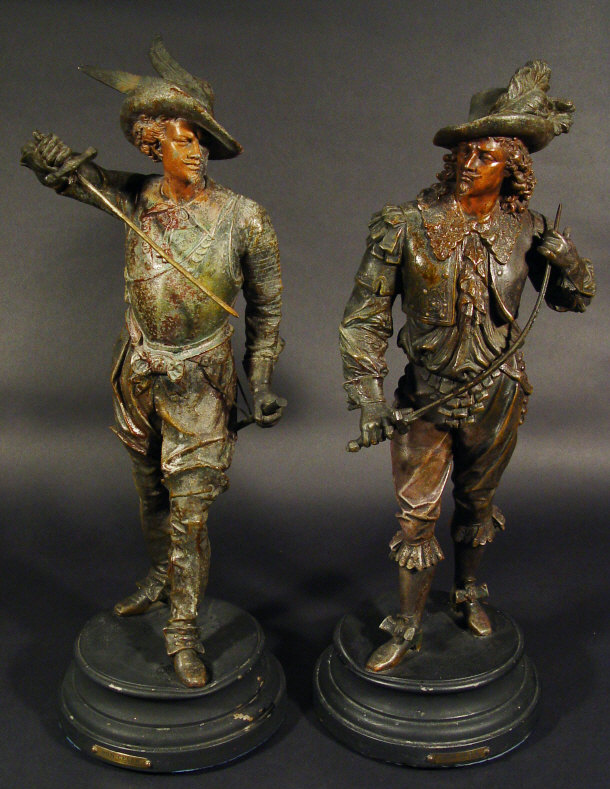 Appraisal: Large pair of spelter figures clutching swords on circular ebonised