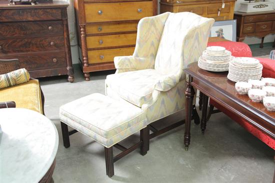 Appraisal: WING BACK CHAIR AND OTTOMAN Walnut frames with reeded legs