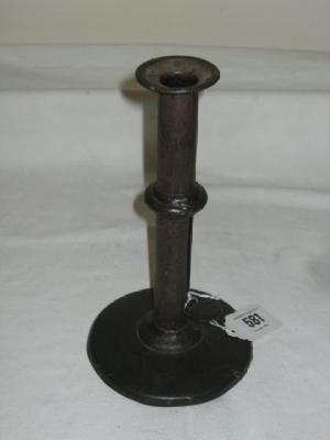 Appraisal: A GEORGE III IRON CANDLESTICK the cylindrical stem with flared