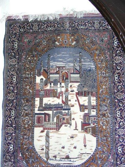 Appraisal: A PERSIAN PRAYER RUG with mosque decoration and inscription within