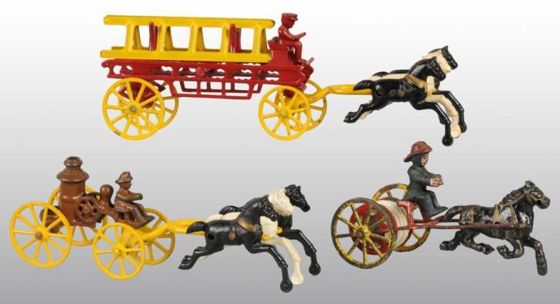 Appraisal: Lot of Cast Iron Horse-Drawn Fire Toys Description This lot