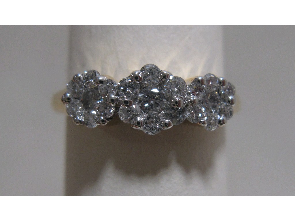 Appraisal: Eighteen carat gold triple flower head cluster diamond ring