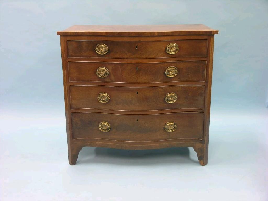 Appraisal: A George III serpentine-fronted mahogany chest four long drawers each