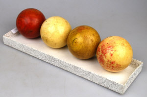 Appraisal: Four turned ivory billiard balls one dyed red