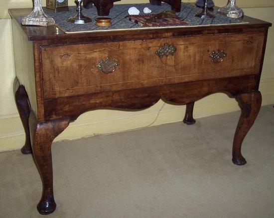 Appraisal: A Queen Anne walnut one-drawer table on cabriole legs with