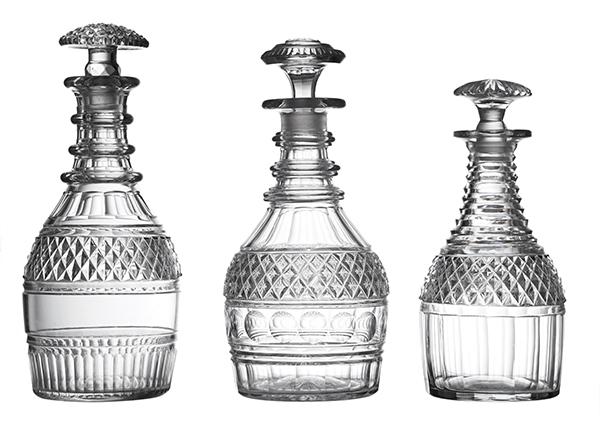 Appraisal: THREE GEORGIAN CUT GLASS DECANTERS WITH STOPPERS Two triple ring