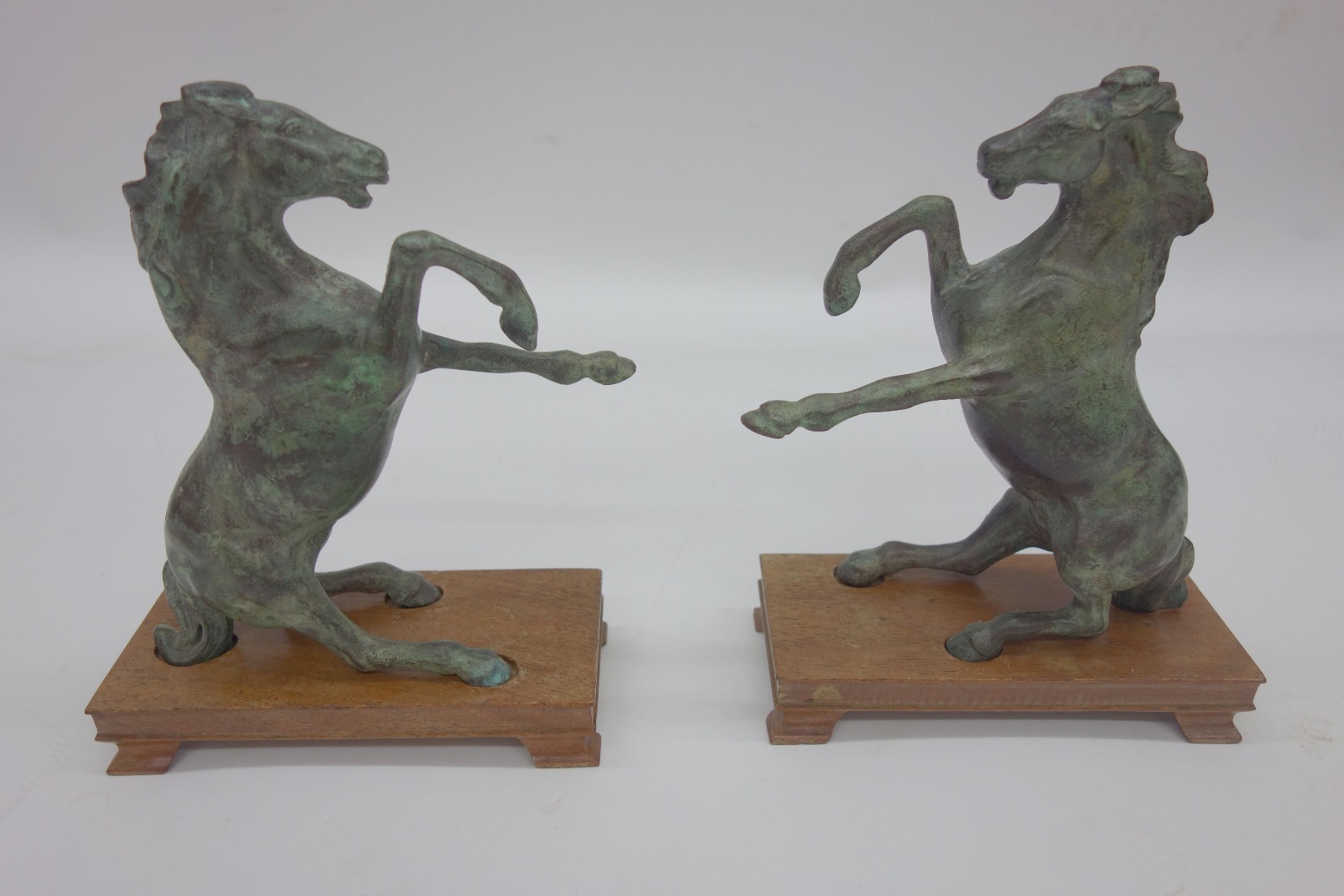 Appraisal: A pair of Chinese patinated bronze models of rearing horses