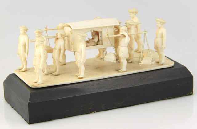 Appraisal: An Indian ivory carving of a palanquin being carried by