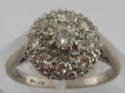 Appraisal: A white metal tests platinum diamond cluster ring estimated total