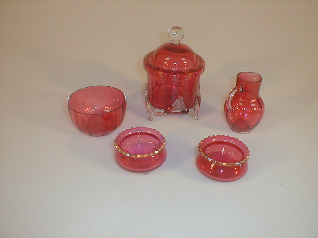 Appraisal: A Cranberry glass cream jug a pair of salts a