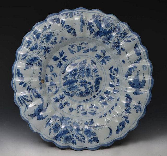 Appraisal: A DELFT LOBED DISH painted with birds and flower sprays