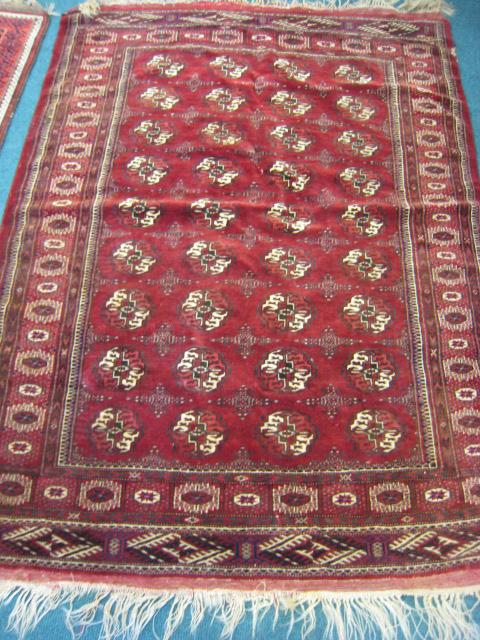 Appraisal: A multi bordered silk Turkoman Carpet on red ground ft