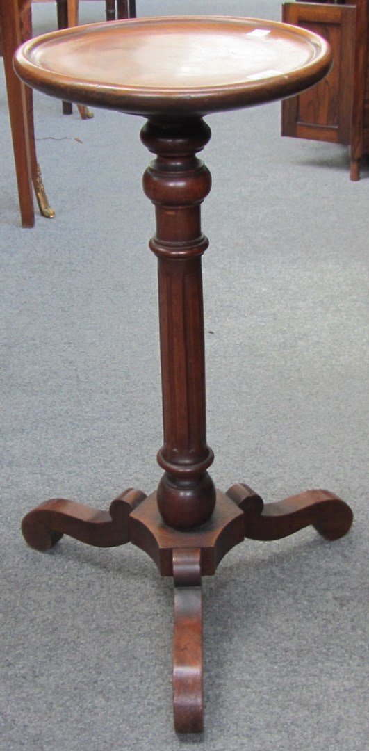 Appraisal: A th century walnut candle stand the dished circular top