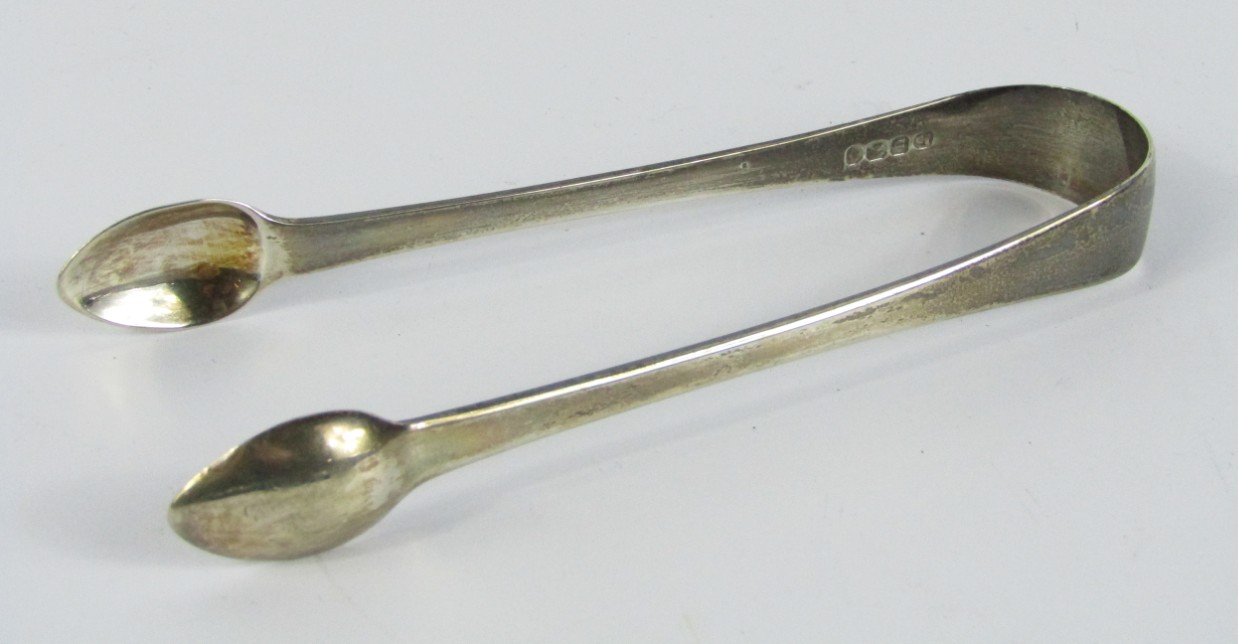 Appraisal: A pair of George IV silver sugar tongs monogram engraved