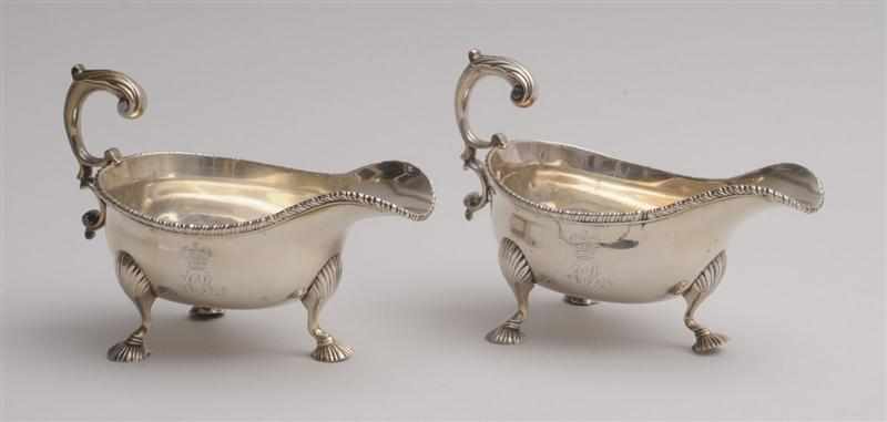 Appraisal: PAIR OF GEORGE II CRESTED AND MONOGRAMMED SILVER SAUCE BOATS