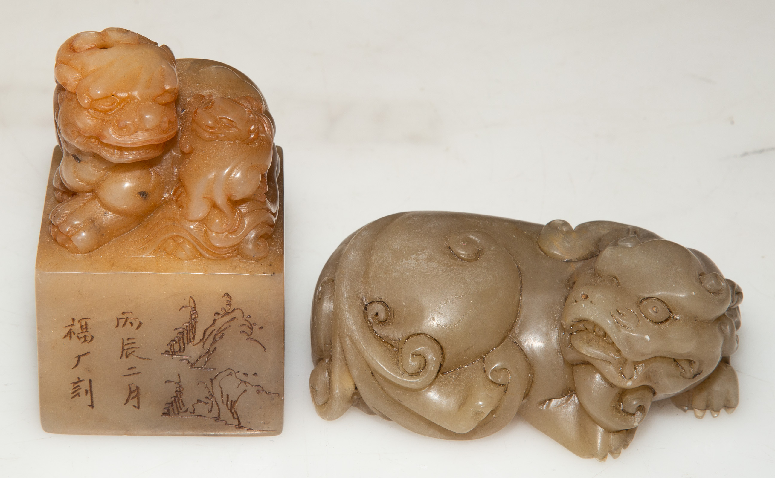 Appraisal: TWO CHINESE CARVED SOAPSTONE FOO LIONS th century including a