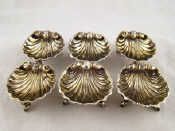 Appraisal: A matched set of six silver shell salts with dolphin