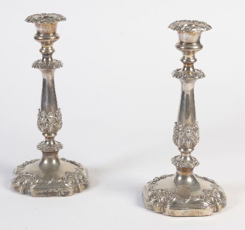 Appraisal: A pair of plated candlesticks the slender baluster stem with