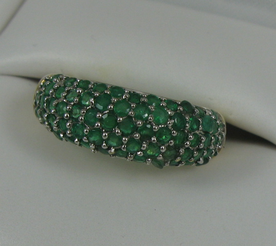 Appraisal: EMERALD AND FOURTEEN KARAT GOLD RING the top half of