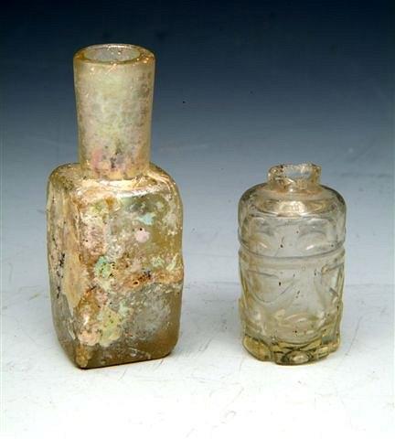 Appraisal: A FATIMID CYLINDRICAL GLASS PERFUME BOTTLE with wheel cut decoration