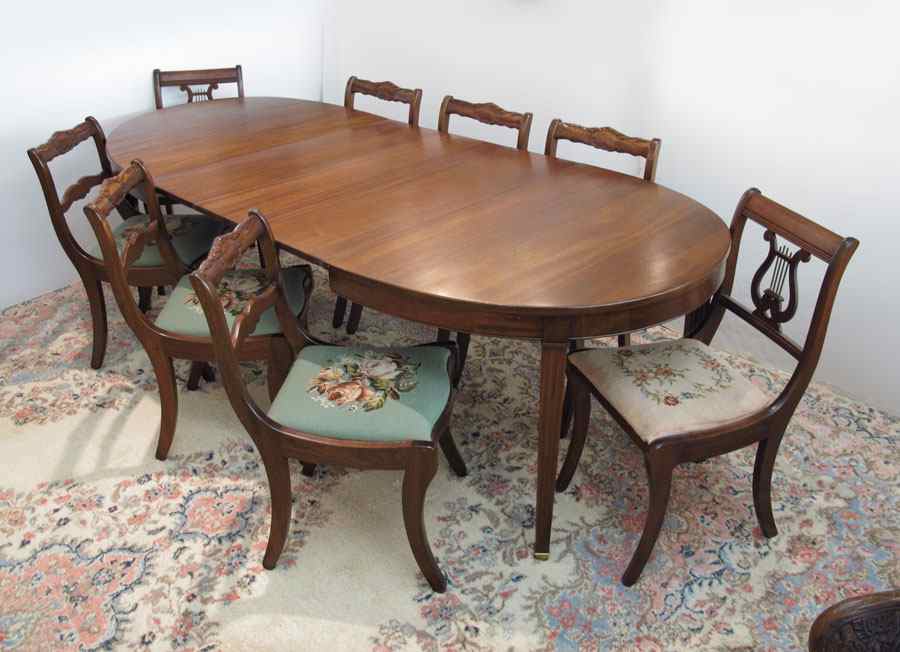 Appraisal: MAHOGANY OVAL DINING TABLE WITH NEEDLEPOINT CHAIRS Splay leg dining