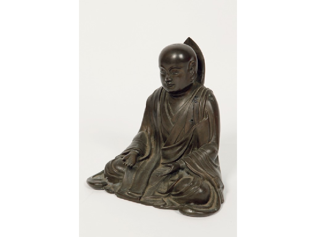 Appraisal: A JAPANESE BRONZE DEITY with an inscription on the reverse