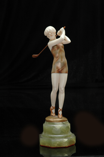 Appraisal: A PATINATED BRONZE AND IVORY FIGURE OF A GOLFER Cast