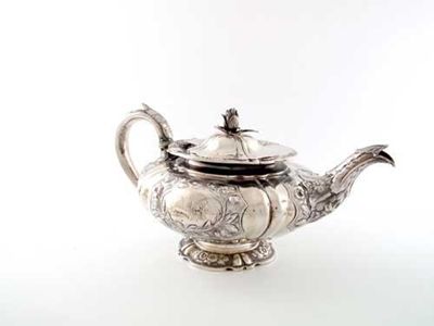 Appraisal: A George IV embossed teapot with a squat shaped circular