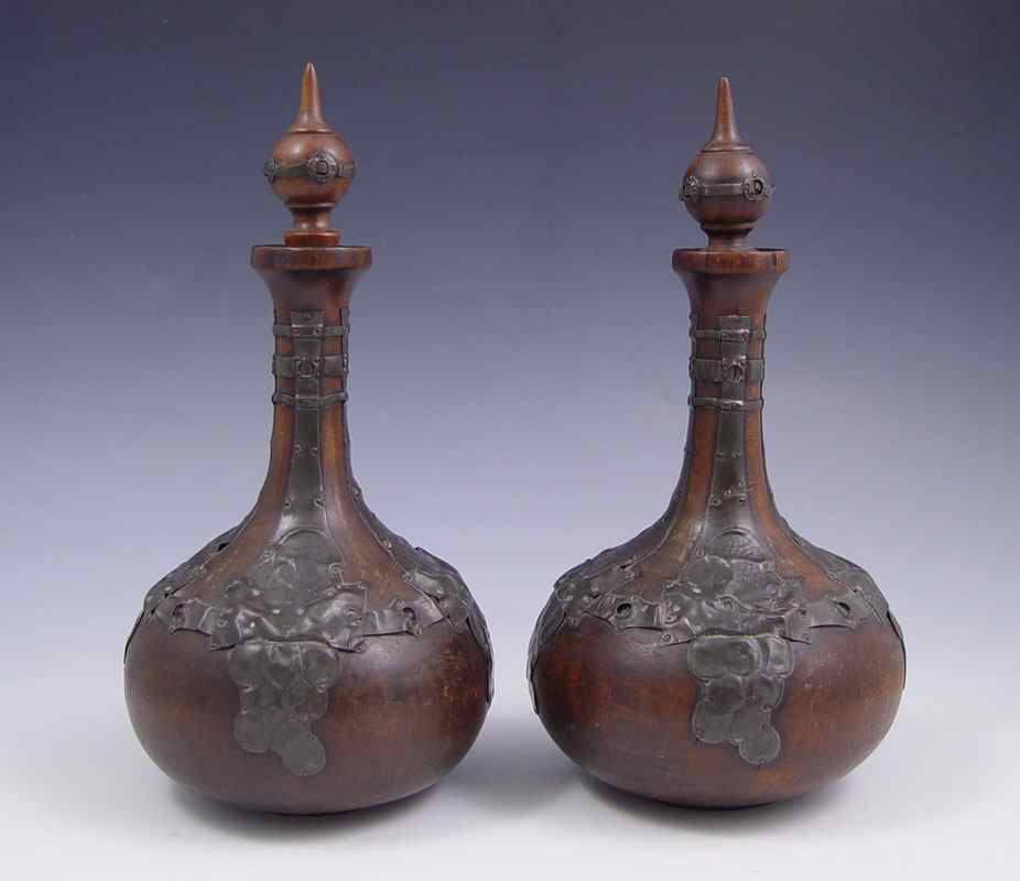 Appraisal: BLACK FOREST METAL MOUNTED NOUVEAU WOODEN BOTTLES Carved wood bottles