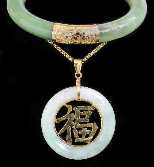 Appraisal: A modern Chinese green jadeite circular stiff bracelet with engraved