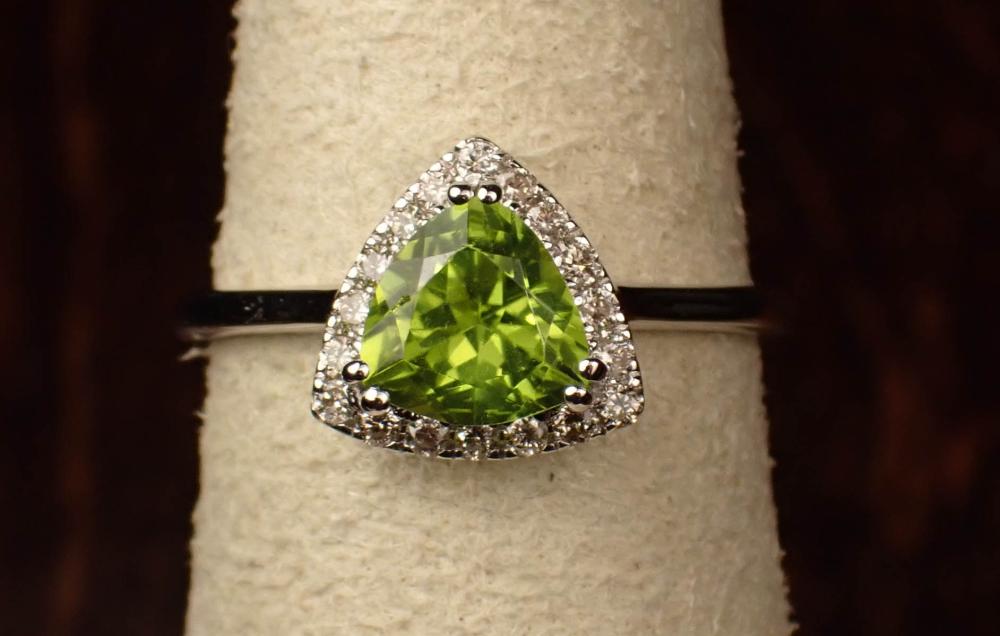 Appraisal: PERIDOT DIAMOND AND FOURTEEN KARAT GOLD RING The white gold