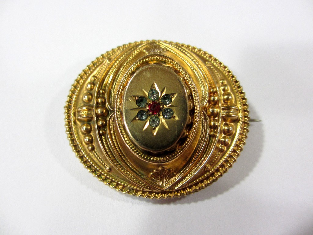 Appraisal: A Victorian Etruscan style balloon brooch with paste centre