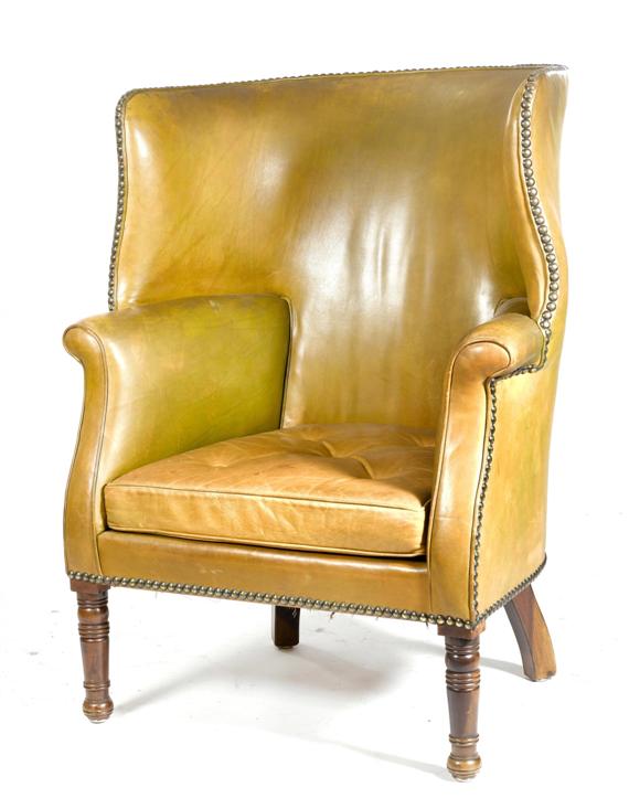 Appraisal: A WINGBACK ARMCHAIR England th c Yellowish leather