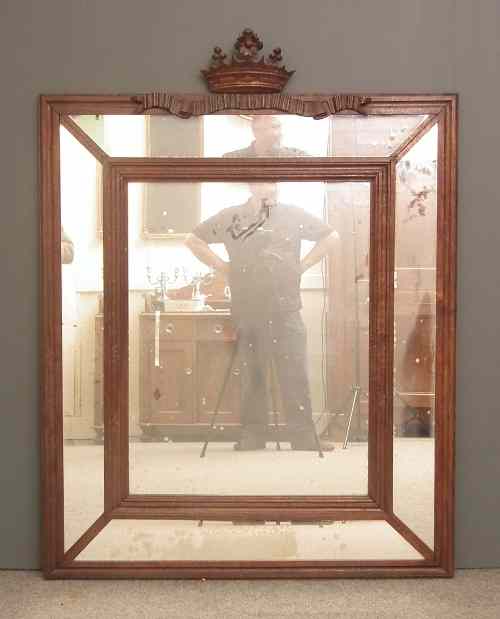 Appraisal: An oak framed rectangular wall mirror with carved crown cresting