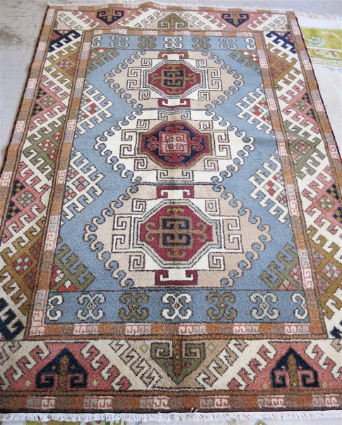 Appraisal: HAND KNOTTED ORIENTAL CARPET Indo-Kazak featuring a column of three