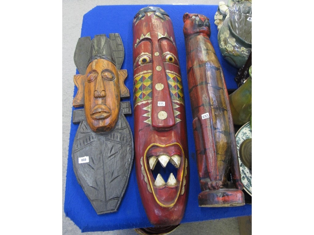 Appraisal: Large carved and painted cat figure and two wall masks