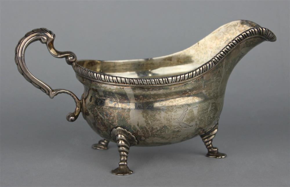 Appraisal: GEORGE II ARMORIAL SILVER SAUCE BOAT London partially legible mark