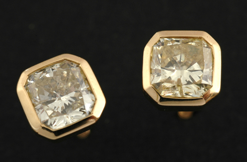 Appraisal: A pair of yellow diamond stud earrings Each set with